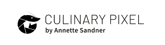 Das Logo von Culinary Pixel in schwarz. Culinary Pixel als Schrift, und links daneben das Bildlogo, das eine schliessende kreisförmige Blende und gleichzeitig eine Gamba darstellt.